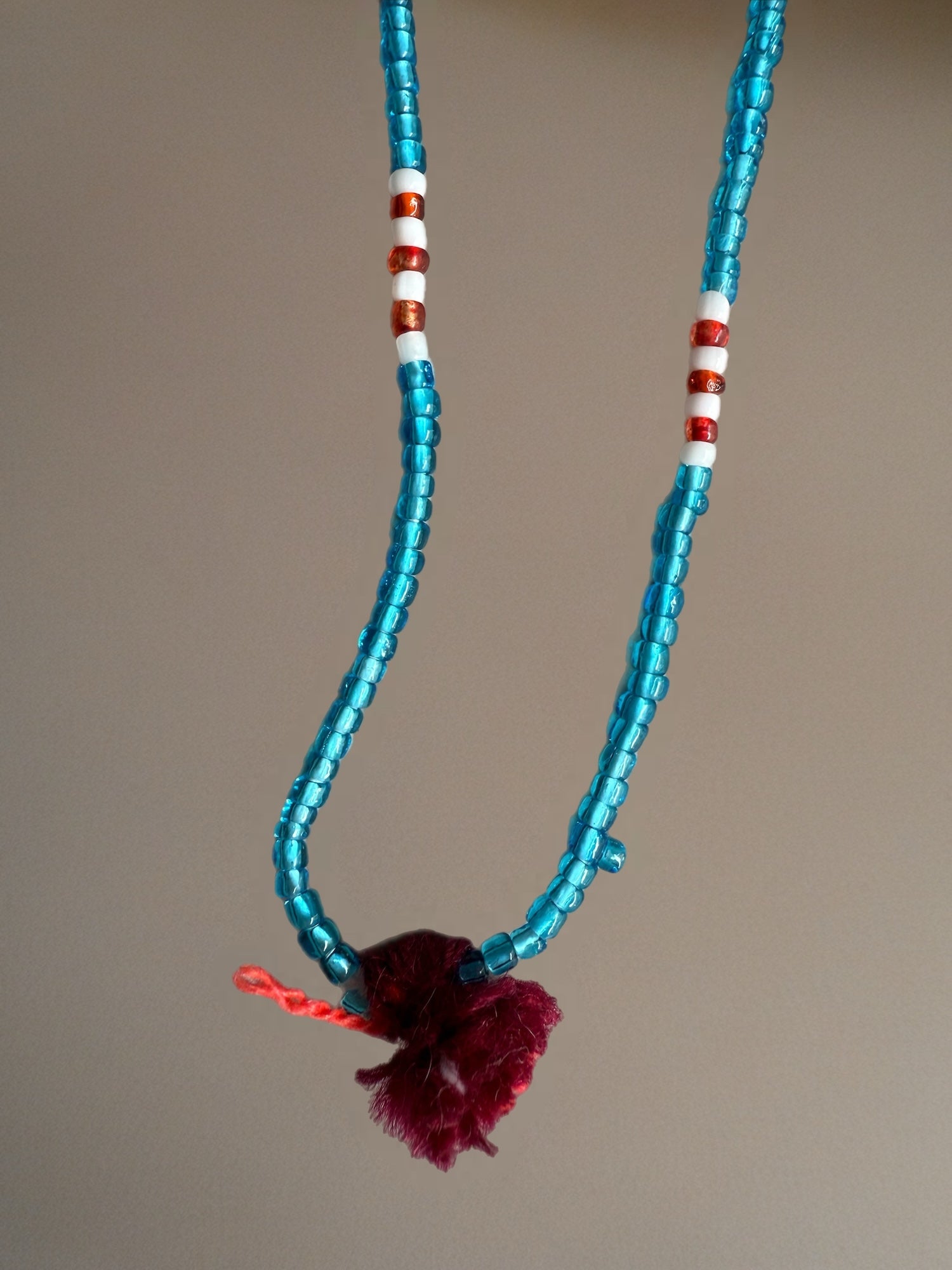 Shanti Necklace - Light Blue with Red Pompom