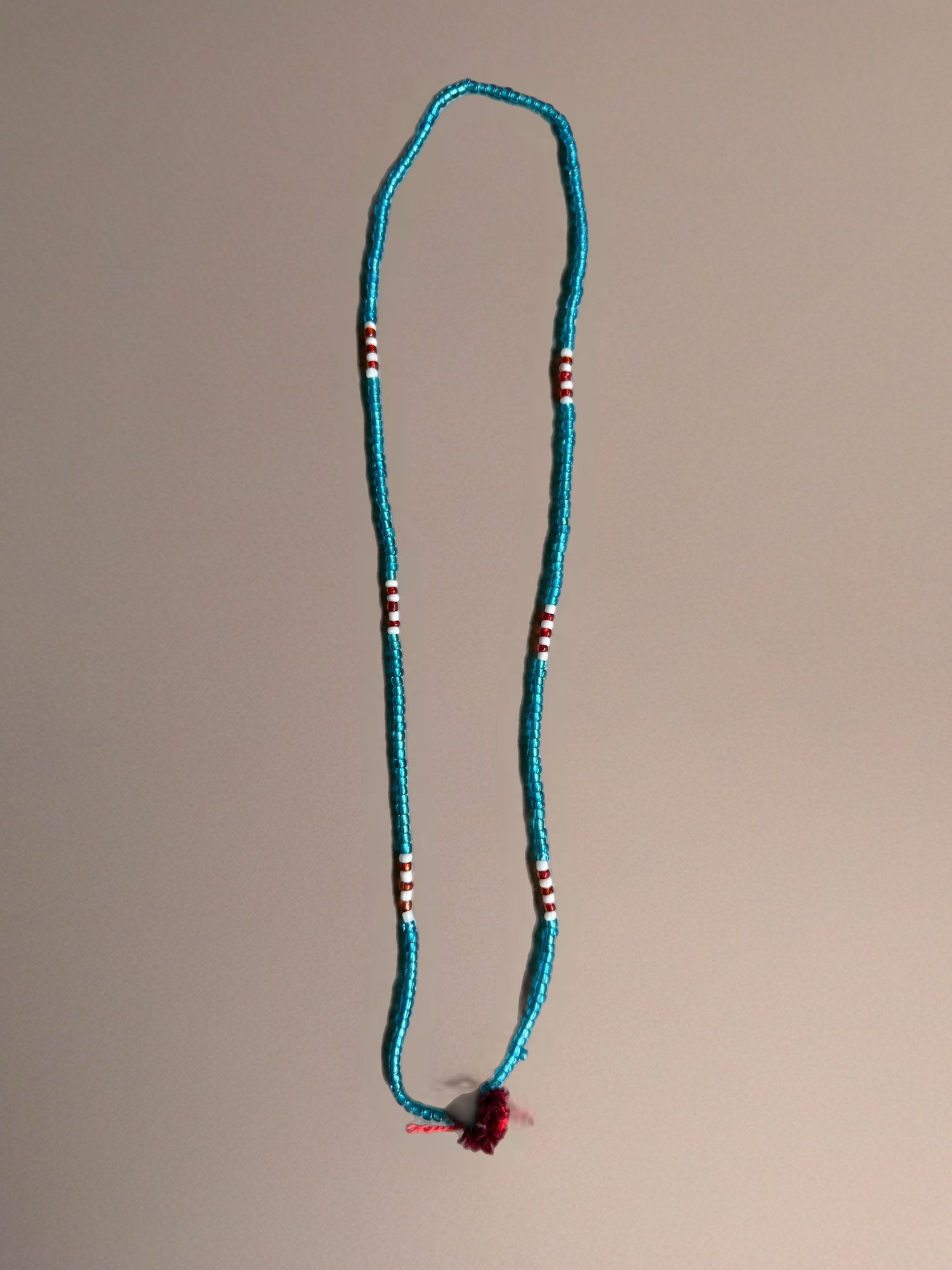 Shanti Necklace - Light Blue with Red Pompom